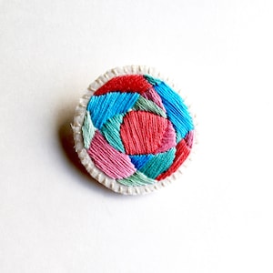 Hand embroidered brooch with round geometric design in bright pinks, blues and green colors on cream muslin Fall fashion An Astrid Endeavor image 1