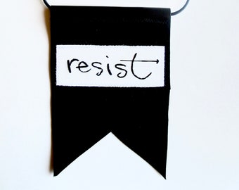 Wall hanging- "Resist" hand embroidered on cream muslin with black leather backing, words of wisdom home decor An Astrid Endeavor