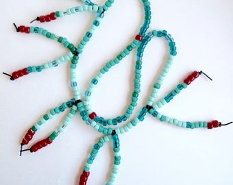Beaded fringe necklace glass beads in mint and and sea green colors with red on an asymmetrical long black leather cord An Astrid Endeavor