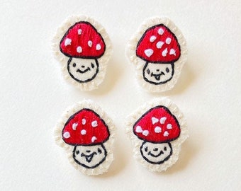 Hand embroidered mushroom brooch in red with white spots on cream muslin with felt backing Magic mushroom kawaii cute An Astrid Endeavor