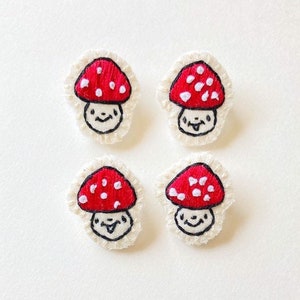 Hand embroidered mushroom brooch in red with white spots on cream muslin with felt backing Magic mushroom kawaii cute An Astrid Endeavor image 1