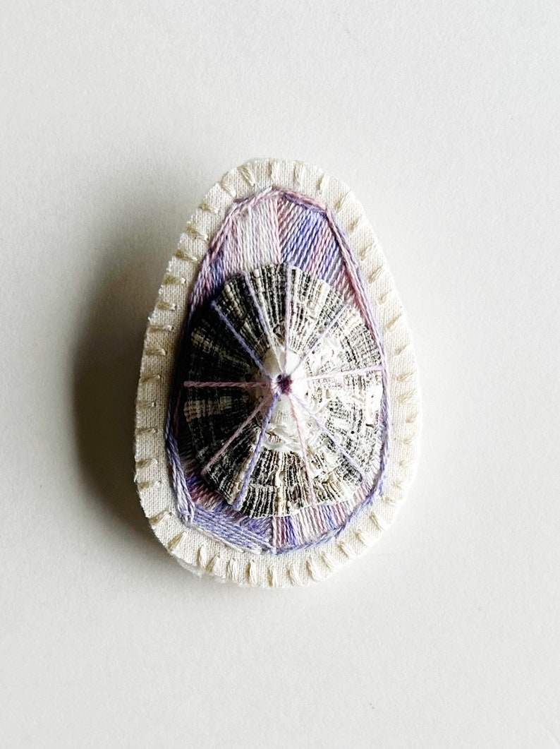 Hand embroidered brooch abstract design using lavender variegated threads and limpet shell An Astrid Endeavor contemporary fiber jewelry image 1