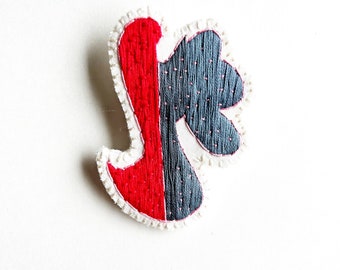 Hand embroidered brooch with unique abstract design using gray red pale pink thread An Astrid Endeavor fiber jewelry modern embroidery