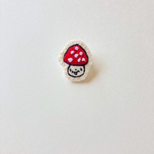 Hand embroidered mushroom brooch in red with white spots on cream muslin with felt backing Magic mushroom kawaii cute An Astrid Endeavor image 3