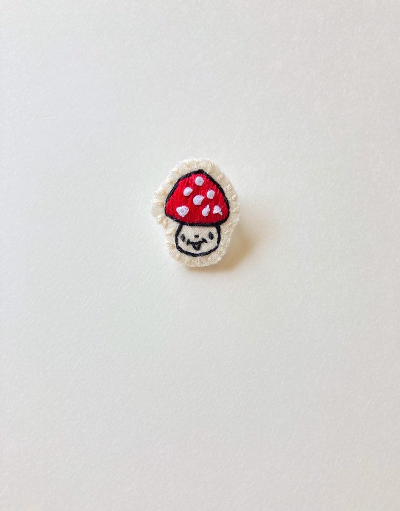 Hand embroidered mushroom brooch in red with white spots on cream muslin with felt backing Magic mushroom kawaii cute An Astrid Endeavor image 3