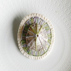 Hand embroidered brooch abstract design using lavender and green variegated threads and limpet shell An Astrid Endeavor fiber jewelry image 6