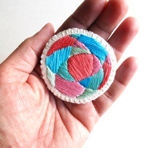 Hand embroidered brooch with round geometric design in bright pinks, blues and green colors on cream muslin Fall fashion An Astrid Endeavor image 3