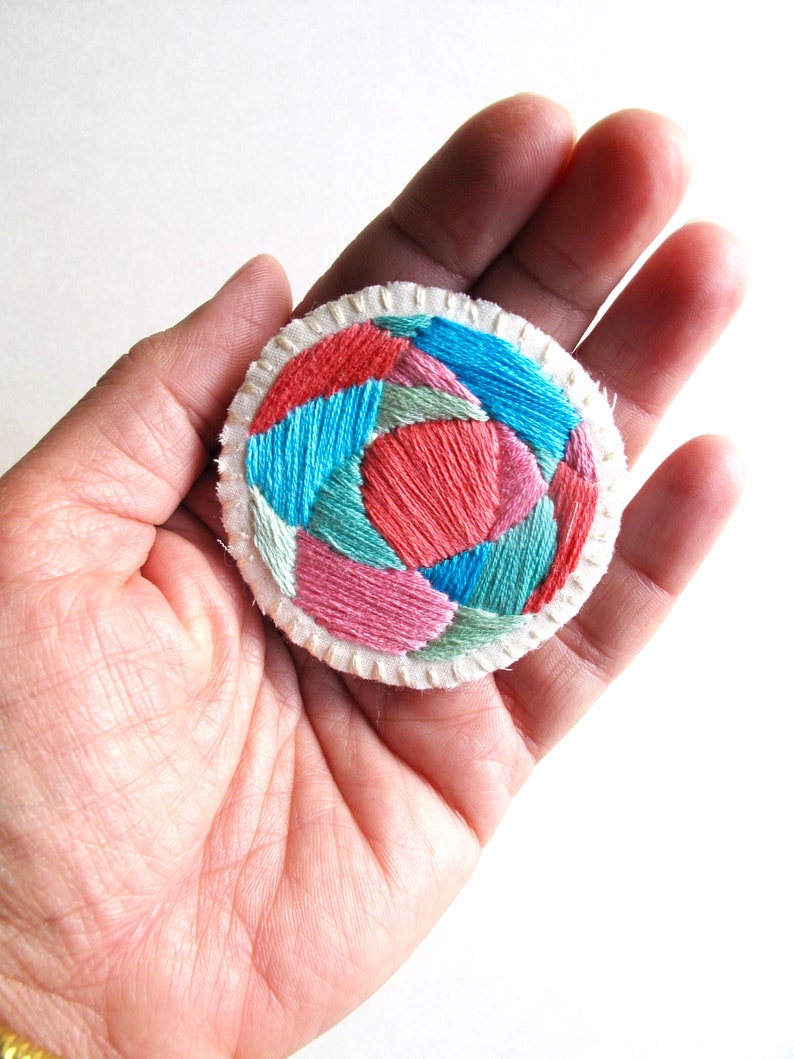 Hand embroidered brooch with round geometric design in bright pinks, blues and green colors on cream muslin Fall fashion An Astrid Endeavor image 3