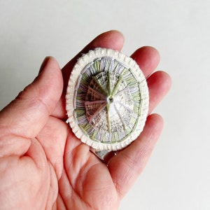 Hand embroidered brooch abstract design using lavender and green variegated threads and limpet shell An Astrid Endeavor fiber jewelry image 4