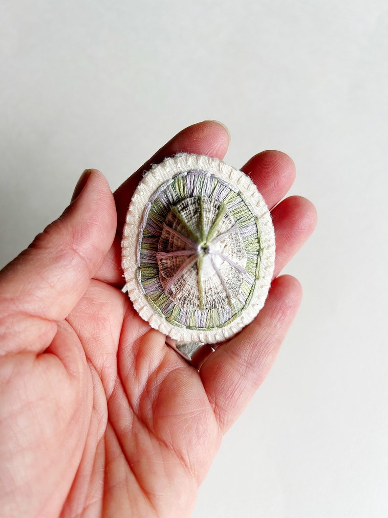 Hand embroidered brooch abstract design using lavender and green variegated threads and limpet shell An Astrid Endeavor fiber jewelry image 4