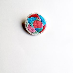 Hand embroidered brooch with round geometric design in bright pinks, blues and green colors on cream muslin Fall fashion An Astrid Endeavor image 2