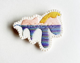 Hand embroidered brooch with unique abstract design using yellow pale pink and variegated purple thread An Astrid Endeavor textile jewelry