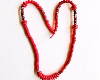 Beaded statement necklace with asymmetrical design red glass beads from India and Native American Crow beads on red leather cord holidays