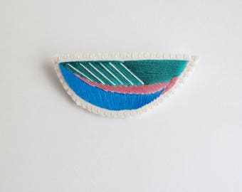 Embroidered abstract brooch in emerald green, bright blue and pink on cream muslin with cream felt backing Spring fashion denim jacket flair