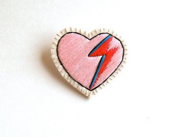 Heart brooch embroidered with pink, red and blue lightning bolt on cream muslin with cream felt back David Bowie tribute Made to order