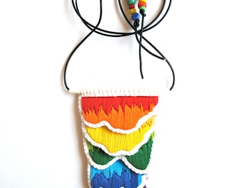 Hypoallergenic embroidered pendant necklace in rainbow colors black leather cord with rainbow glass beads hand embroidered on cream muslin