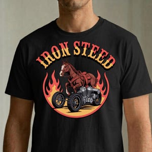 Puede incluir: Camiseta negra con un gráfico de un caballo marrón con montura, integrado con un motor y ruedas de motocicleta, rodeado de llamas. El texto "IRON STEED" está arqueado sobre el caballo.