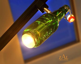 Track light; Green glass beer bottle; Swing-top cap.