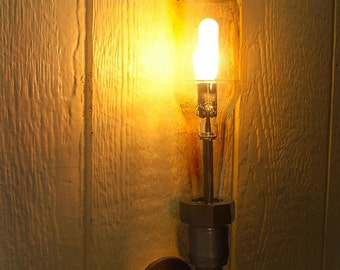 Wall Light. Lamp. Beer bottle, Plumbing pipe & fittings. Wall light. Lighting Fixture. Sconce