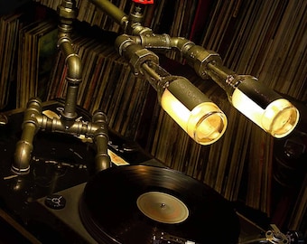 Desk lamp. Beer bottles. Plumbing pipe & fittings. Table lamp.