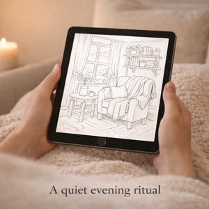 May include: A tablet displays a black and white illustration of a cozy living room scene with a window, armchair, and side table. The tablet is held by hands resting on a soft, textured blanket. Text at the bottom reads "A quiet evening ritual."