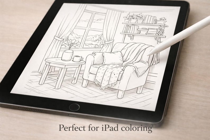 May include: An iPad displays a black and white line drawing of a cozy living room scene. The illustration includes a comfortable armchair with a blanket, a small side table with a cup and plant, and a window with curtains. A white stylus hovers over the drawing.