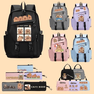 May include: A collection of backpacks, pencil cases, and tote bags featuring capybara illustrations. The backpacks come in black, gray, lavender, pink, and blue, with multiple compartments and adjustable straps. Pencil cases and tote bags also display capybara designs.