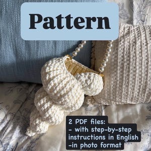 May include: A crocheted seashell-shaped bag in cream color with a pearl strap. The word "Pattern" is displayed on a light blue background. The image also includes text indicating two PDF files with step-by-step instructions in English.