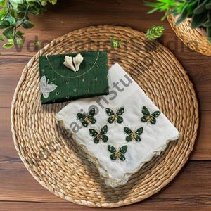 May include: A white ceramic mug with a black handle and the text "But First, Coffee" in a handwritten style. The mug is on a white surface. The mug is approximately 4 inches tall.