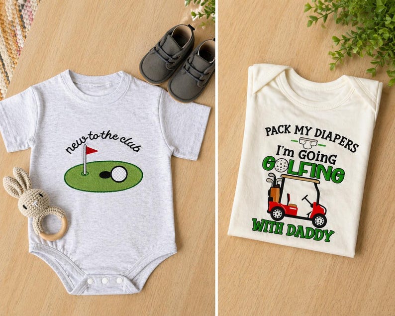 May include: Two baby onesies with golf-themed designs. One is light gray with "new to the club" text and a golf course graphic. The other is cream-colored with "Pack my diapers I'm going golfing with Daddy" text and a golf cart graphic. Gray baby shoes and a toy are also present.