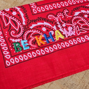 rainbow colored name embroidery. name embroidered on a paisley cowboy western bandana. party bandana, party favors