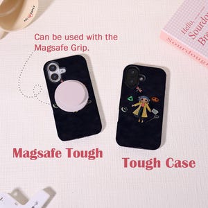 May include: Two black phone cases with unique designs. One features a light pink MagSafe grip, the other a cartoon character. Text on the cases reads "Magsafe Tough" and "Tough Case." The cases are shown on a light-colored surface.