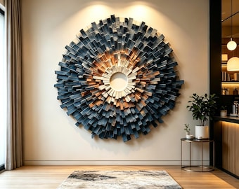 May include: A large circular wall sculpture composed of numerous radiating wooden slats. The slats transition in colour from a dark charcoal grey on the outer edges to a warm natural wood tone near the centre, which features a hollow circular opening.