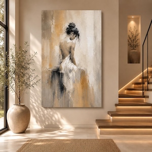 May include: A vertical rectangular canvas painting featuring an abstract depiction of a figure with dark hair in a bun, viewed from behind. The figure is draped in white fabric against a textured background of blended beige, gold, and gray tones.