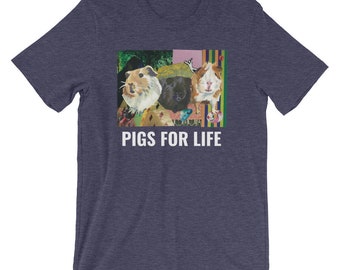 Könnte beinhalten: Ein marineblaues T-Shirt mit einem Grafikdruck von drei Meerschweinchen vor einem bunten, abstrakten Hintergrund. Der Text "PIGS FOR LIFE" ist in Weiß unter dem Grafikdruck aufgedruckt.