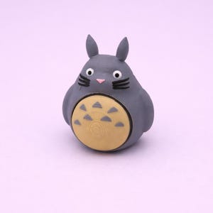 May include: A white ceramic mug with a black handle and the text "But first, coffee" in a black, handwritten-style font. The mug is on a white surface.