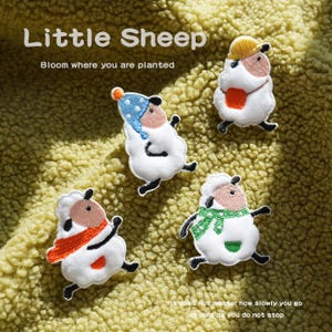 May include: Four embroidered sheep patches with the text "Little Sheep" and "Bloom where you are planted". Each sheep has a unique design, including hats and scarves. The bottom of the image reads "It does not matter how slowly you go as long as you do not stop."