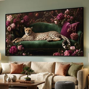 May include: A framed canvas print depicting a cheetah reclining on a green velvet sofa. The cheetah has black spots and is surrounded by pink and purple flowers. The background is dark with decorative elements.