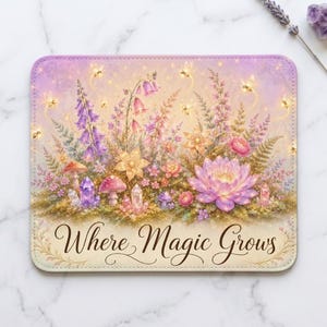 May include: A rectangular mouse pad featuring a vibrant illustration of purple and pink flowers, mushrooms, and crystals. Small glowing fireflies are scattered throughout the scene. The text Where Magic Grows is printed in a dark script font at the bottom.