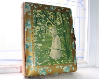 possibly Brundage Victorian Celluloid Photo Album depicting an Adorable Girl holding Her Kitten