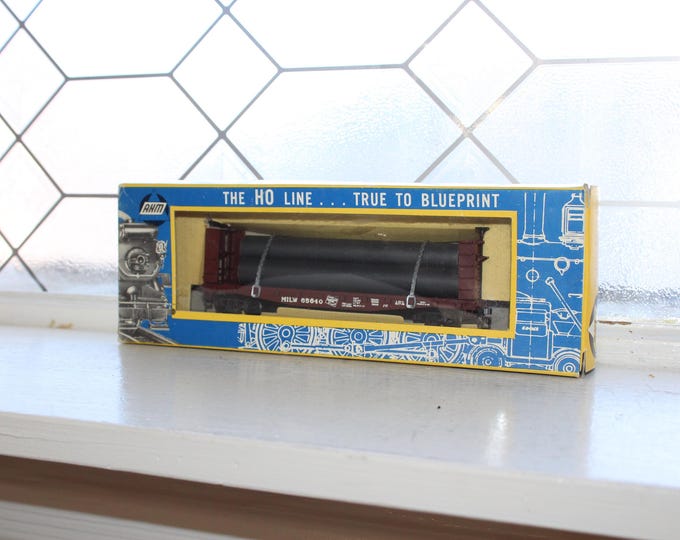 Vintage AHM HO Scale Milwaukee Railroad Flat Car with Pipes 65640