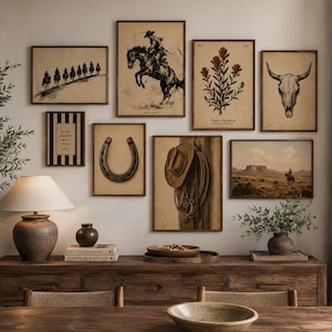 May include: A gallery wall arrangement featuring eight framed prints with western themes, including a cowboy on horseback, a horseshoe, a skull, and a hat with rope. The prints are displayed above a wooden sideboard with a lamp and decor.