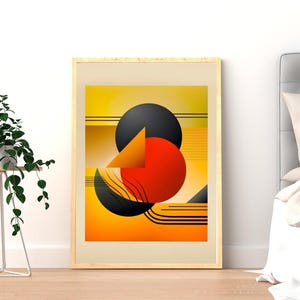 May include: Framed abstract art print featuring geometric shapes in shades of yellow, orange, and black. The artwork includes circles, triangles, and curved lines, creating a modern and colorful composition. The print is displayed in a light wood frame.
