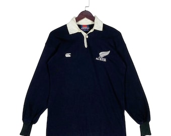 Camiseta de rugby vintage de los 90 de Canterbury, Nueva Zelanda, All Blacks, talla pequeña, hecha en Nueva Zelanda, color negro, cuello blanco, manga larga.