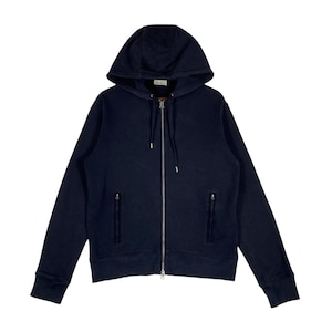 May include: A navy blue zip-up hoodie with a drawstring hood and two front pockets. The hoodie features a full-length zipper and ribbed cuffs and hem. The brand name is visible on the hood.
