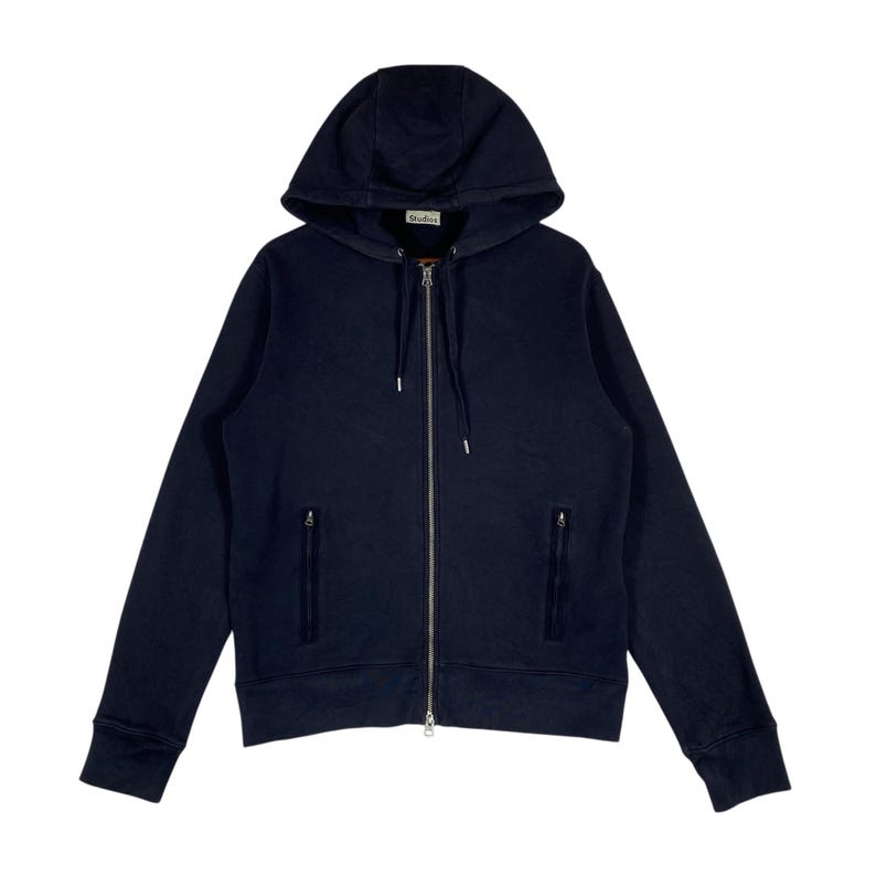 May include: A navy blue zip-up hoodie with a drawstring hood and two front pockets. The hoodie features a full-length zipper and ribbed cuffs and hem. The brand name is visible on the hood.