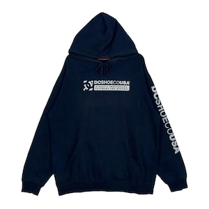 May include: A navy blue hooded sweatshirt featuring a white graphic on the chest that reads DCSHOECOUSA ATHLETIC SKATEBOARD FOOTWEAR AND APPAREL. The left sleeve also displays the text DCSHOECOUSA in white lettering. It includes a front kangaroo pocket.
