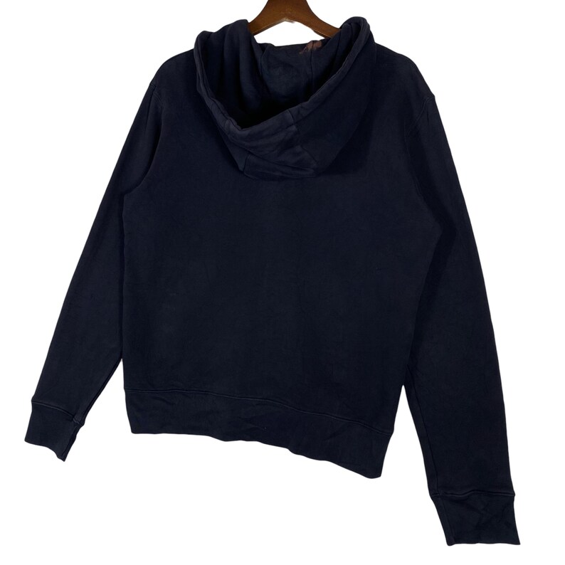 May include: A navy blue hoodie with a drawstring hood and long sleeves. The sweatshirt is made of a soft material and is hanging on a wooden hanger. The back of the hoodie is visible.