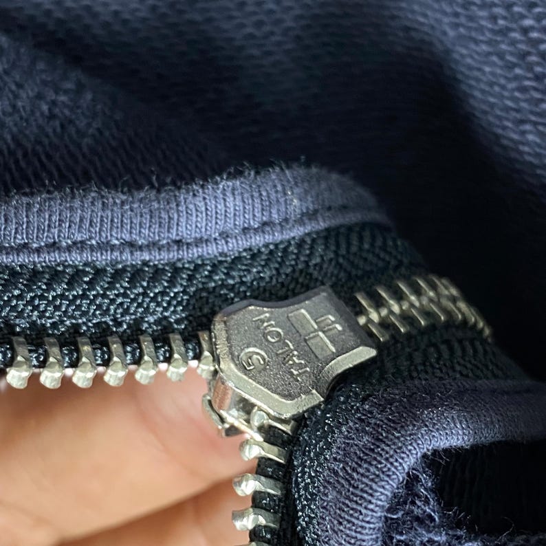 May include: A set of three ceramic mugs with a speckled, matte finish. The mugs are in shades of cream, light gray, and dark gray. Each mug has a simple, minimalist design, perfect for coffee or tea.