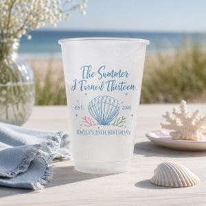 Peut inclure: Un gobelet en plastique givré avec le texte bleu The Summer I Turned Thirteen, EST. 2005 et EMILY'S 20TH BIRTHDAY. Le motif comprend une illustration centrale de coquillage bleu entourée de petits accents coralliens roses et verts.